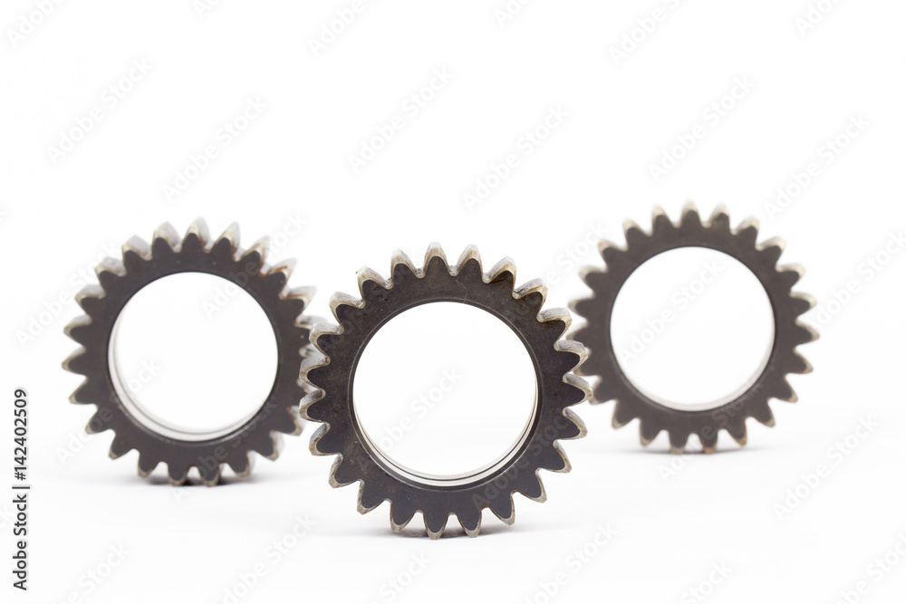 Small group of gears with their teeth engaged on a white background. Small group of gears with their teeth engaged on a white background.