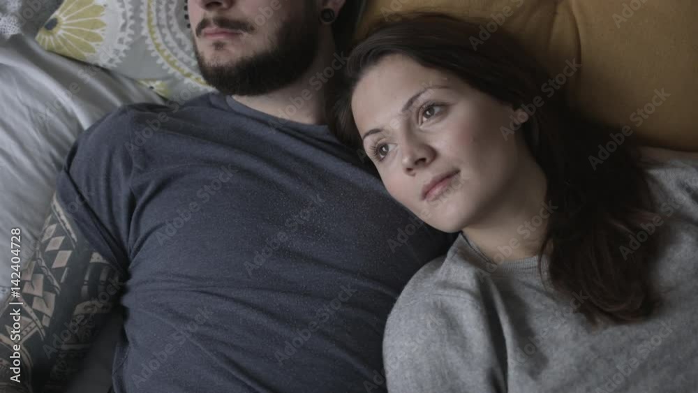 Overhead shot young couple relaxing in bed