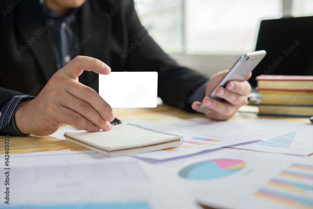 man verifies account balance on smartphone with mobile banking application.Online payment,Businessmen's hands holding a credit card and using smart phone for online shopping 
