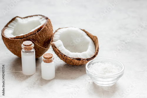 fresh coconut with cosmetic oil in jar on white background