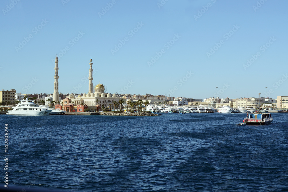 Hurghada sea side view with great muslim mosque and port of modern yachts and boats Hurghada sea side view with great muslim mosque and port of modern yachts and boats