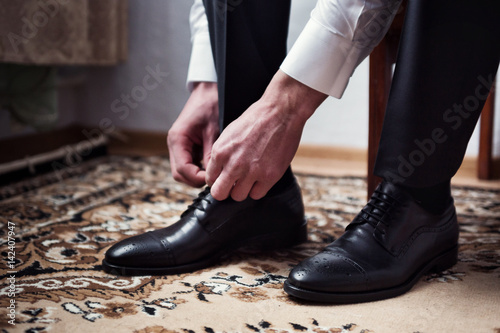 businessman clothes shoes, Politician, man's style, Businessman buttoning his shirt,male hands closeup, American, European businessman, People, business, fashion and clothing concept