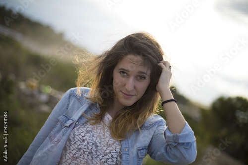 Girl looking at camera while collecting hair