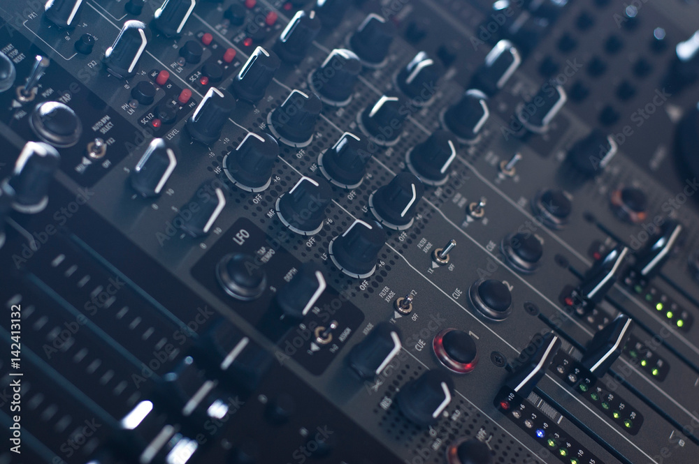 DJ audio mixer knobs in side light