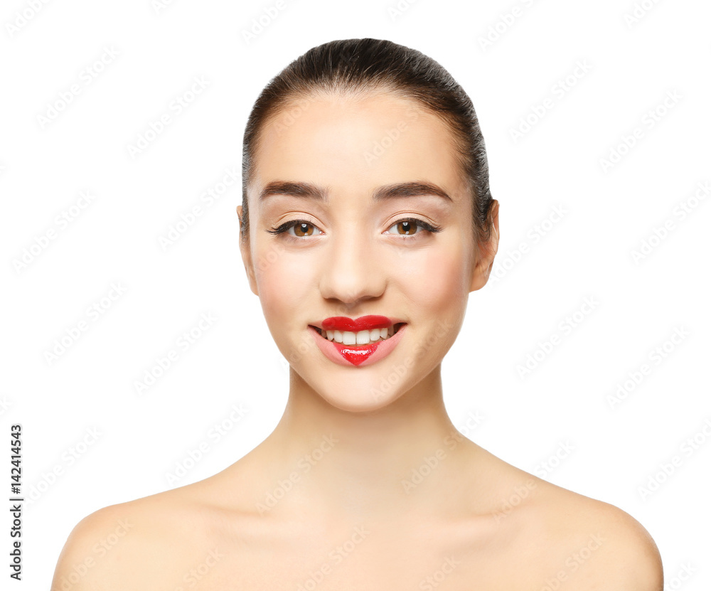 Portrait of beautiful young woman with heart painted on lips, against light background Portrait of beautiful young woman with heart painted on lips, against light background