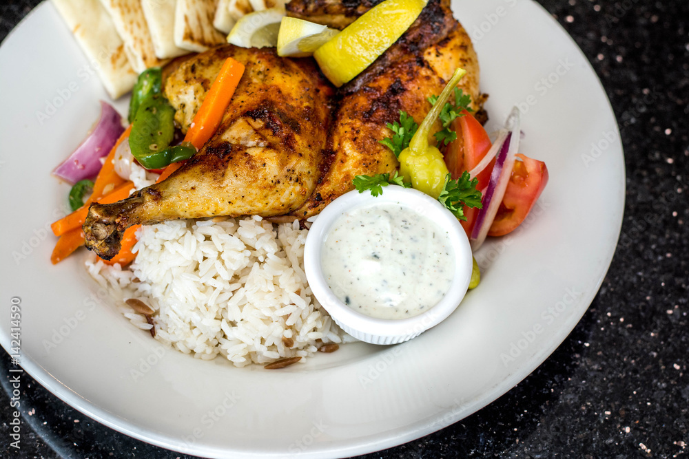 Pita bread, rice, grilled chicken and veggies on the plate Pita bread, rice, grilled chicken and veggies on the plate