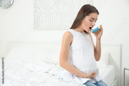 Young pregnant woman using ...