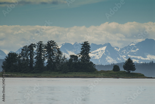 Tiny Island and Magnificent Baranof Island in Background, Kake, Alaska photo