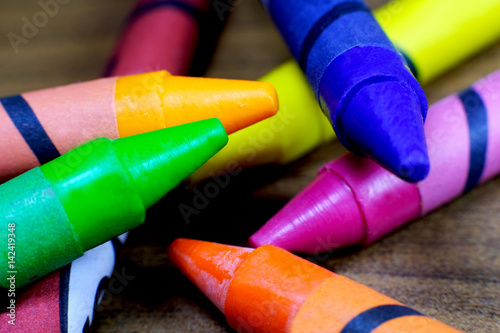 Colorful crayons on wooden table. photo