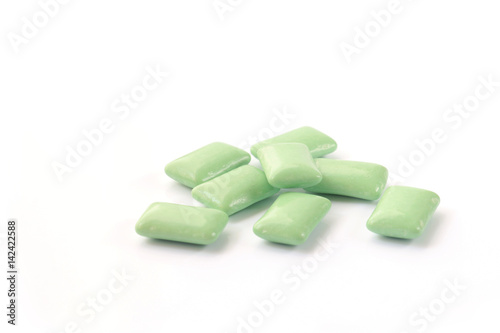 green mint chewing gum tablet on white