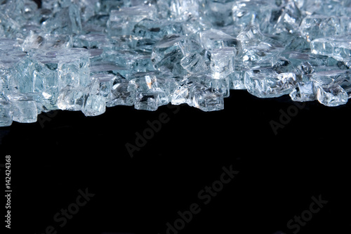 Ice cube background isolated on black with copy space.