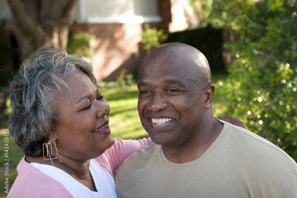 Mature African American couple laughing and hugging. Mature African American couple laughing and hugging.