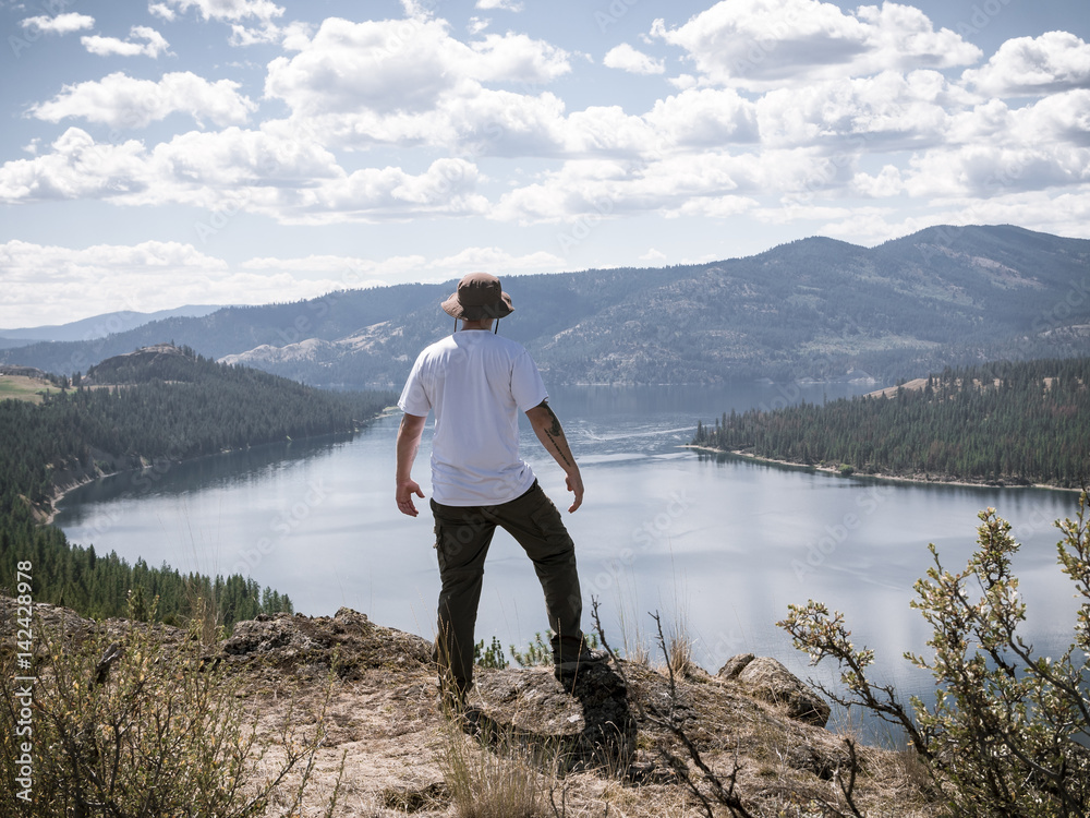 Hiker Standing on Cliff Looking Out at Lake Roosevelt in Pacific Northwest