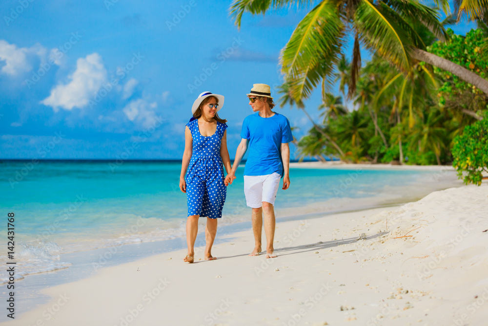 happy loving couple walking on summer beach happy loving couple walking on summer beach