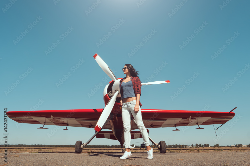 Fototapeta premium Woman pilot and airplane