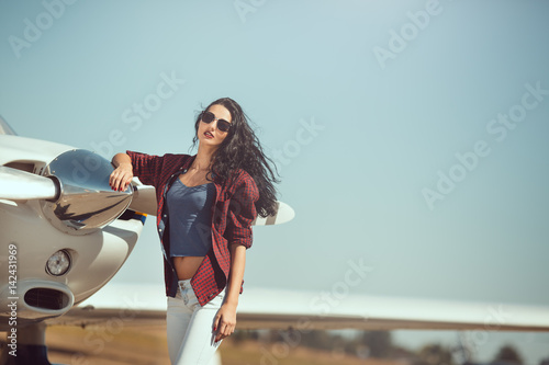 Woman pilot and private business airplane