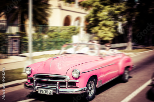 Tourists riding in oldtimer car in Havana. Concept of Cuba attractions. © Ekaterina_Molchanova