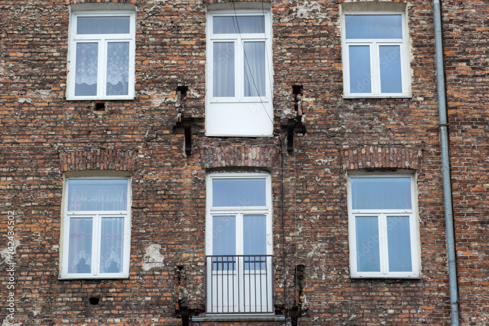 Window on the brick facade of an old house
