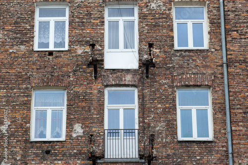 Window on the brick facade of an old house © Bogdan