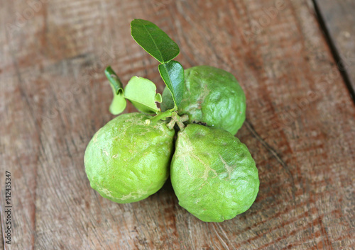 bergamot fruit with leaf on wood table © zilvergolf
