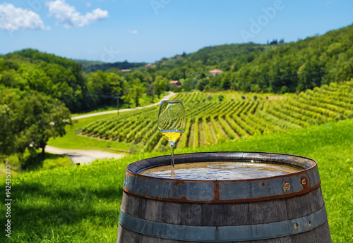 glass of white wine on wooden barrel