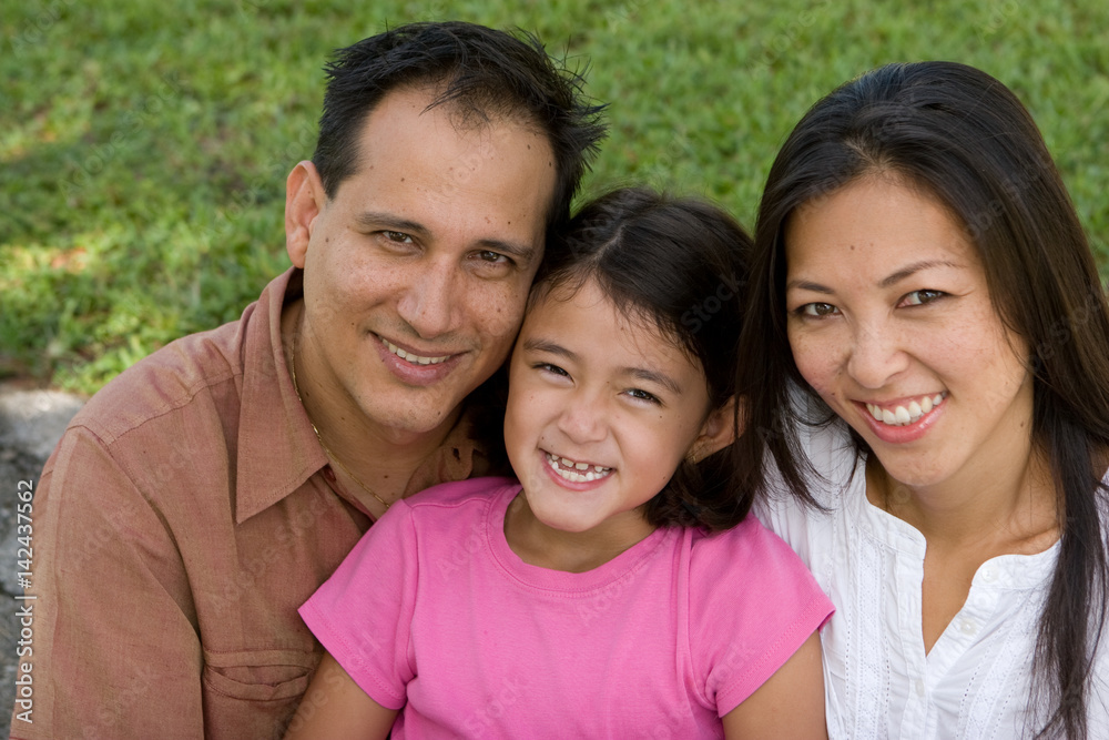 Loving Asain parents and their daughters smiling. Loving Asain parents and their daughters smiling.