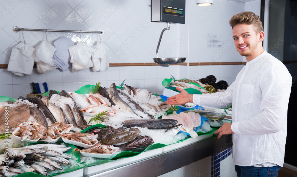 Adult customer buying fish and chilled seafood