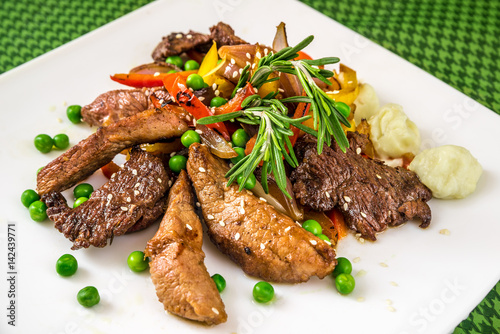 meat with vegetables, peas and herbs