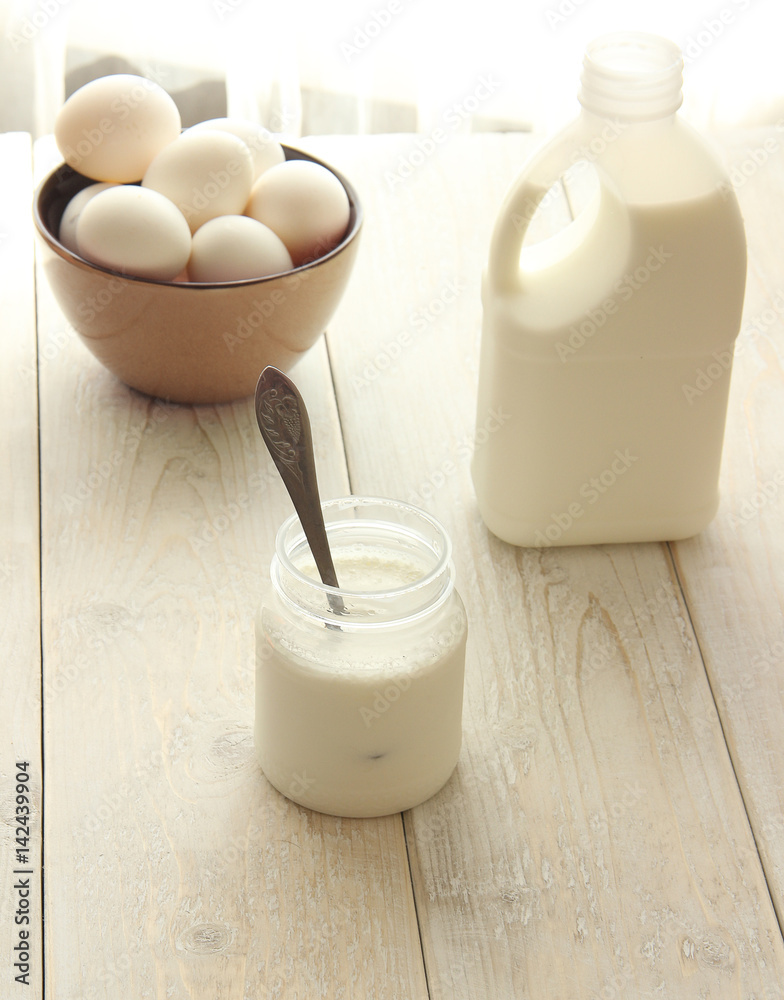 Dairy products on wooden table. Sour cream, milk, cheese, egg, yogurt and butter. Top view Dairy products on wooden table. Sour cream, milk, cheese, egg, yogurt and butter. Top view