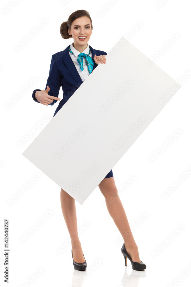 Smiling Air Stewardess Holding White Placard And Pointing Smiling Air Stewardess Holding White Placard And Pointing