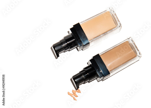 Light beige color liquid concealer closed and open bottle and brush  used for covering blemish on the skin  isolated on white background  with clipping paths