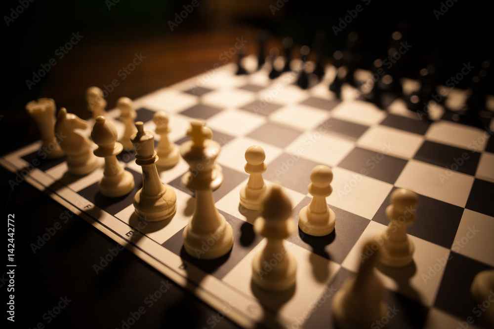 White and black pieces on chess board White and black pieces on chess board