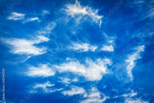 Bright blue sky and fluffy beautiful clouds. Nature background, wallpaper.