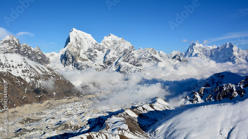 Majestic view of the Himalayan mountains from Mt. Gokyo Ri. Mountain range covered with snow on the background of blue sky.