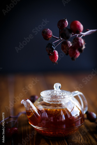 Dried red rose hips and tea photo