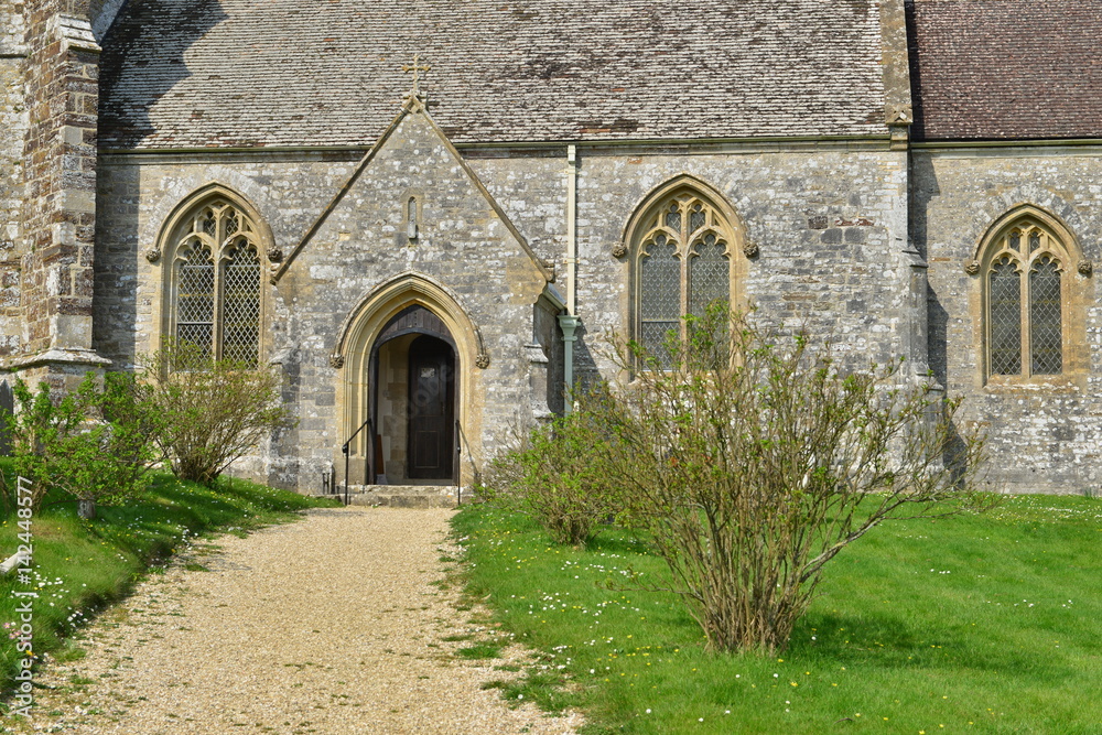 The entrance to Lulworth church in the afternoon sun.
