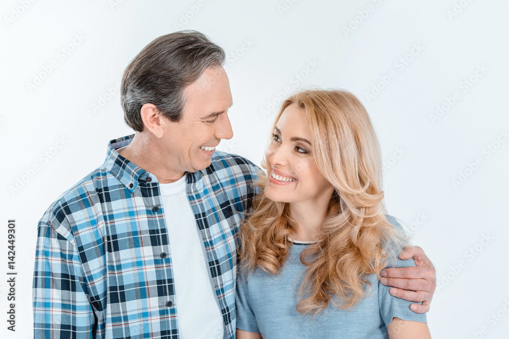 Front view of man and blonde woman embracing and smiling on white Front view of man and blonde woman embracing and smiling on white
