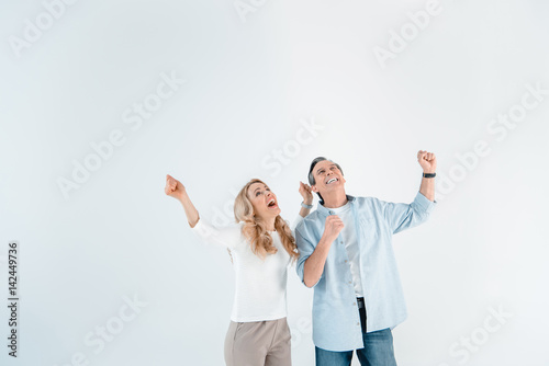 portrait of excited stylish mature man and woman on white