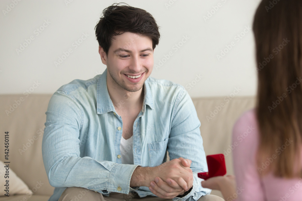Φωτογραφία Marriage proposal of woman, giving box with engagement ring, girlfriend asking boyfriend to marry her, indoors, girl initiative, embarrassing moment