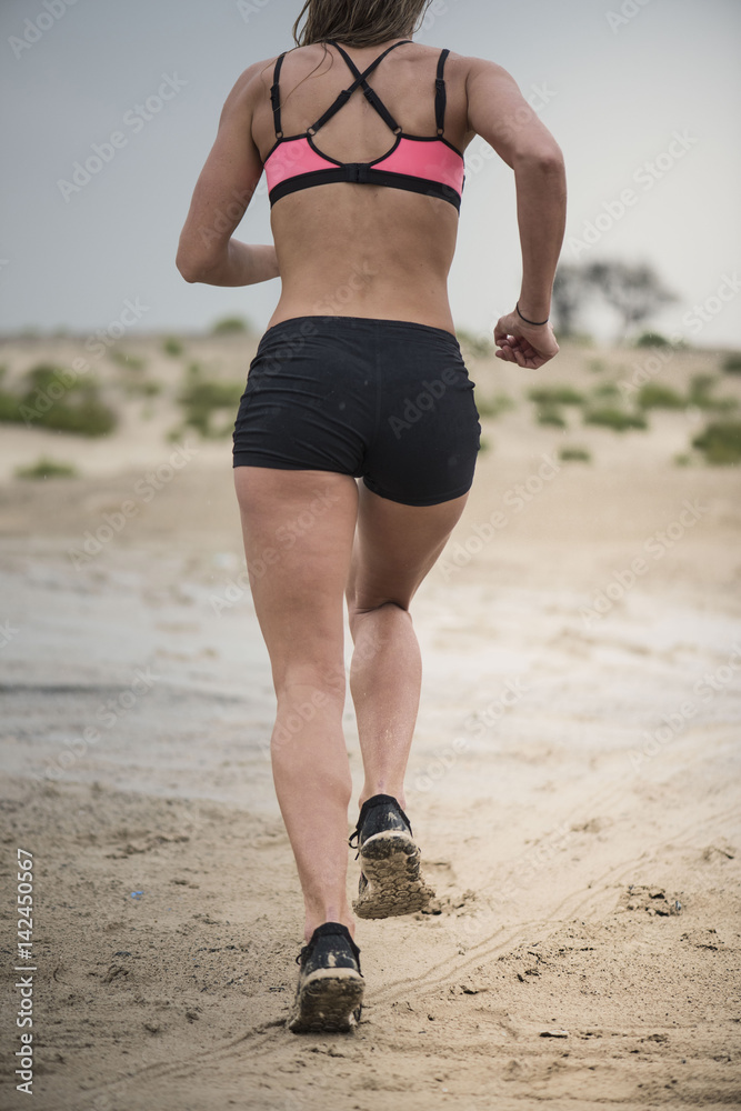 Closeup of strong female runner showing her tight shorts long legs with a  sports top Stock Photo