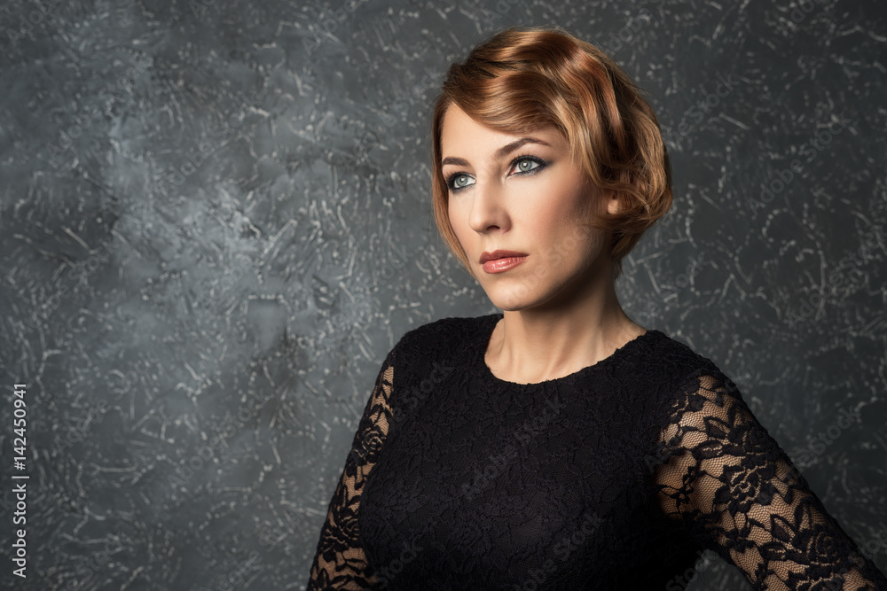 classical portrait of elegant blonde woman with a wave hairstyle and makeup on textural background