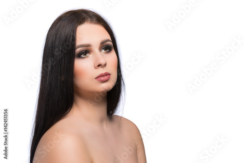 Beauty woman face portrait with clean fresh skin, long hair and bright evening make up.Isolated