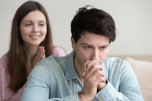 Billede på lærred Sad frustrated guy thinking about accepting or rejecting apology of a girl