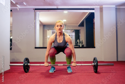 Blonde girl weight lifting