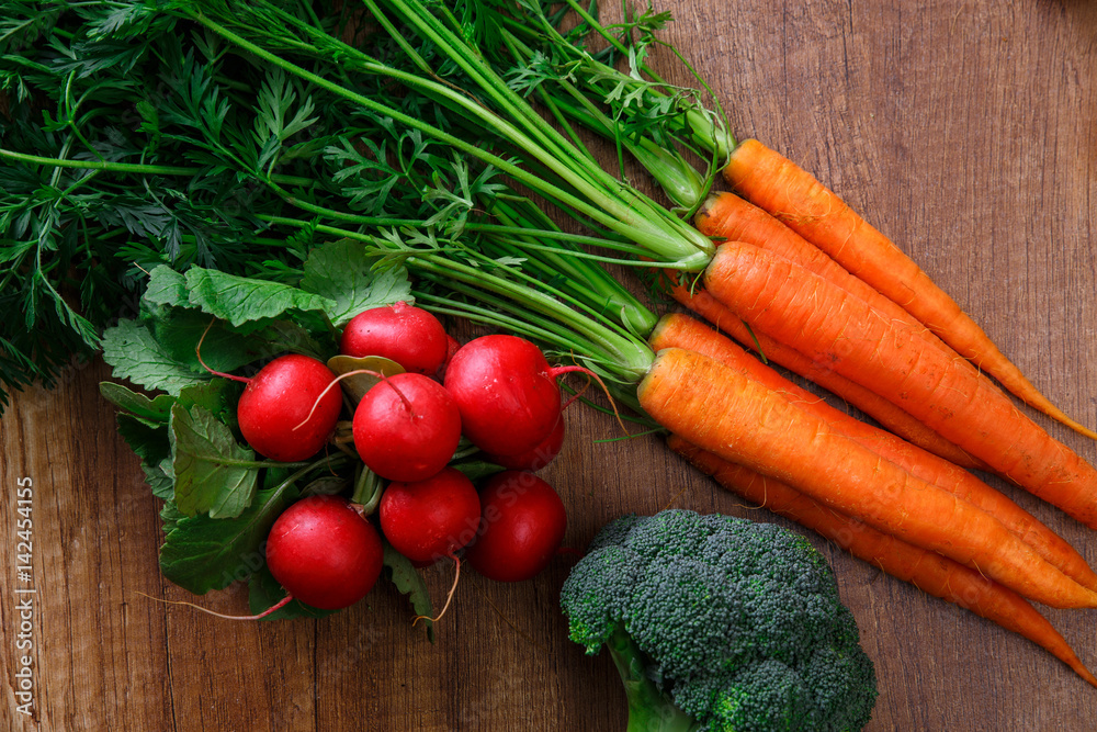 Carrot, red radish and brocoli. Fresh natural vegetables. Organic bio food on wooden table. Carrot, red radish and brocoli. Fresh natural vegetables. Organic bio food on wooden table.