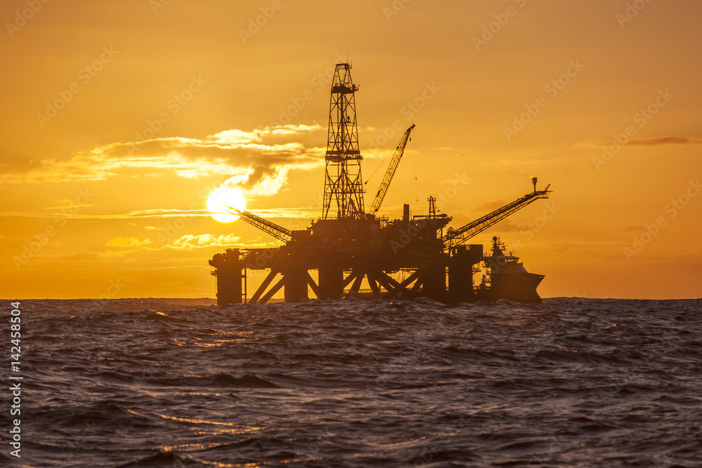 Offshore Jack Up Rig in The Middle of The Sea at Sunset Time 