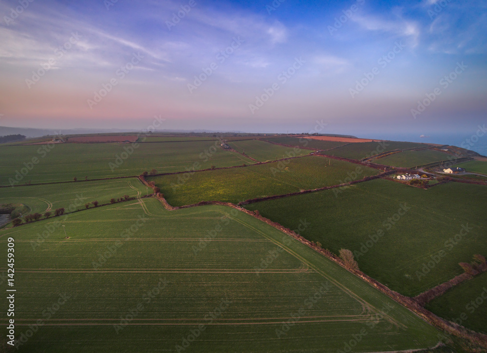Naklejka premium Sunset above fields