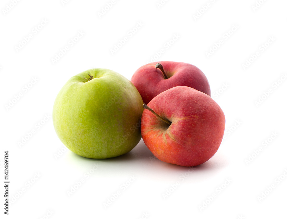 Two red and one green ripe apples on a white background..