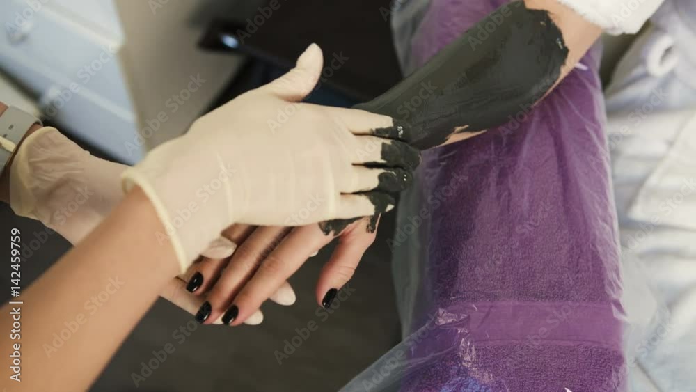 Close up view of professional master applying clay on womans hands in spa salon. Procedure of hands massage in beauty salon. Hand care. Close up view of professional master applying clay on womans hands in spa salon. Procedure of hands massage in beauty salon. Hand care.