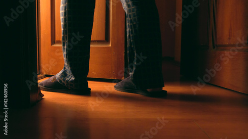Adult man walks to a bathroom at the night